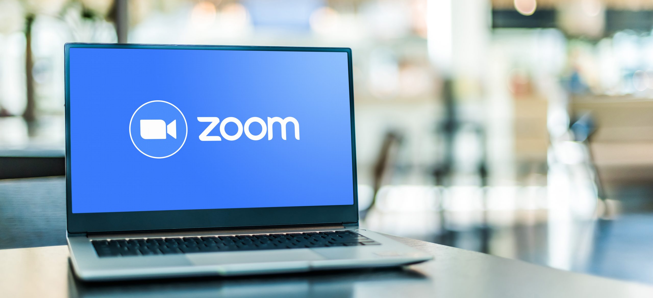 Laptop computer displaying logo of Zoom