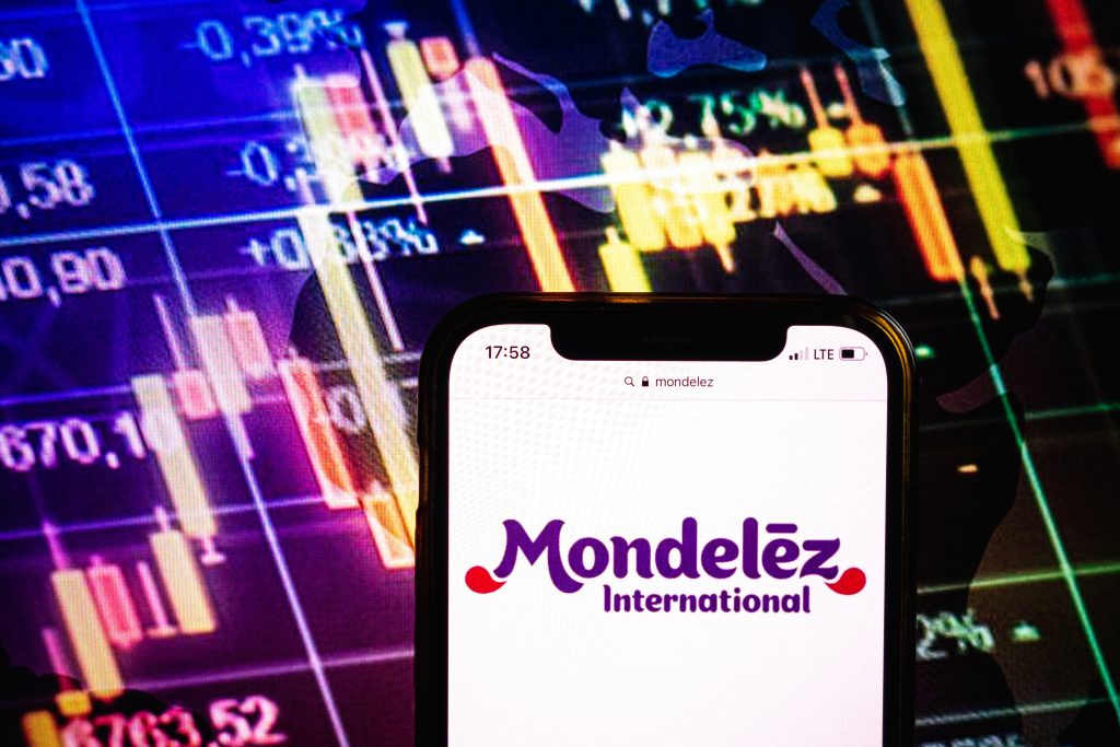 Cellphone showing the Mondelez logo in front of stock graph
