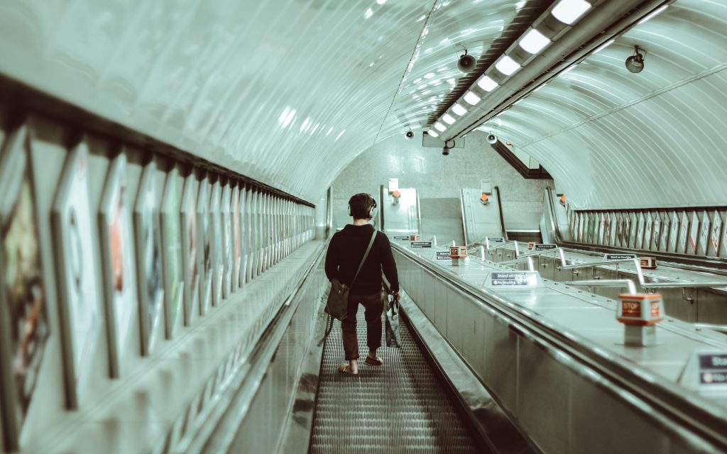 Man walks down the escalator towards the subway platforms