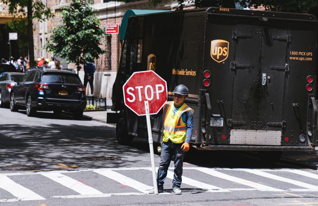 UPS worker setting a stop sign on the street